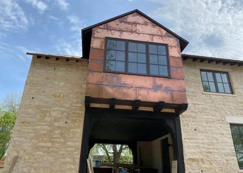 Copper metal panel facade on a stone building for Skylight Installation in Lompoc